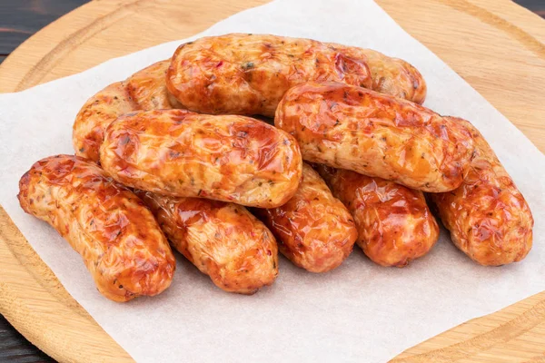 Tasty grilled sausage on the wooden background — Stock Photo, Image