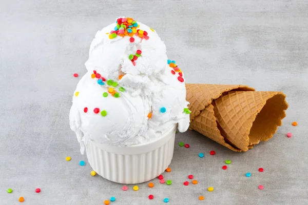 Teller Vanilleeis mit Streusel und Waffelkegel — Stockfoto