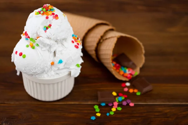 stock image plate of vanilla ice cream scoop swith sprinkles chocolate piece