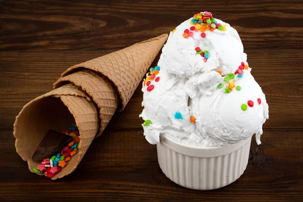 Plate of vanilla ice cream scoop swith sprinkles and waffle cone — Stock Photo, Image