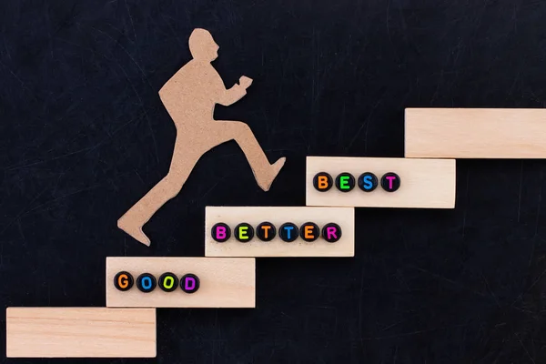 Good - Better - Best paper man climbing the steps to success in — Stock Photo, Image