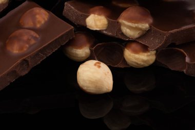 koyu arka planda fındık ile sütlü çikolata parçaları