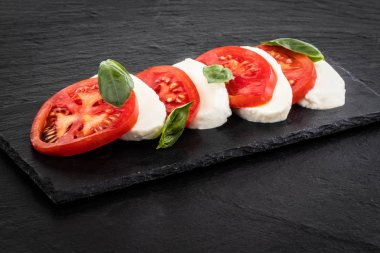 Caprese salatası. Mozzarella peyniri, domates ve fesleğen ot yaprakları