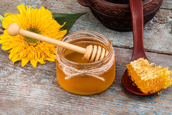 Honey background. Fresh honey in the pot with honeycombs