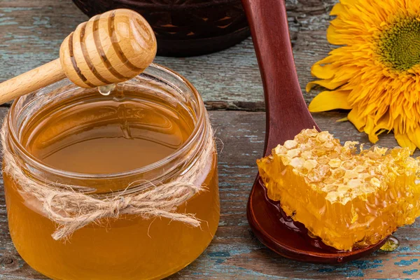 Honey background. Fresh honey in the pot with honeycombs