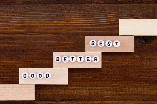 Good - Better - Best. On the wooden background