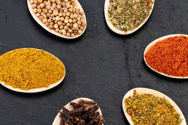 Colourful various herbs and spices on dark background. Top view — ストック写真