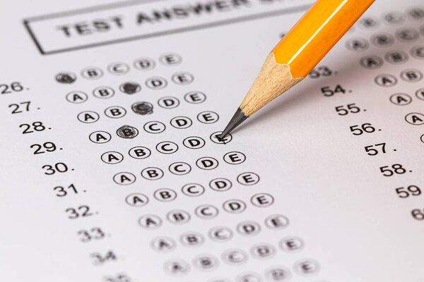 Answer sheet form with pencil on table, close up. Concept of passing exam.