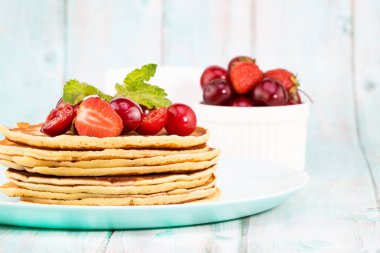 Krep kahvaltısı. Taze böğürtlen ve bal ile ev yapımı krepler, fotokopi alanı ile ışık arka plan.