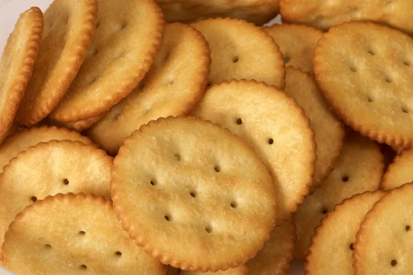 Close up of golden round butter crackers — Stock Photo, Image