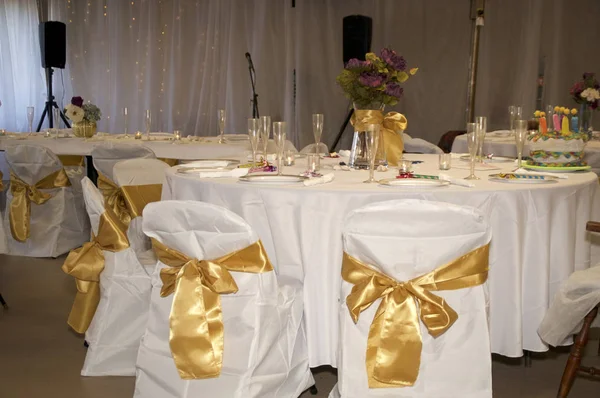 chairs with bows at wedding reception party