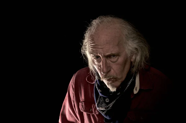 Old cowboy portrait against black background — Stock Photo, Image