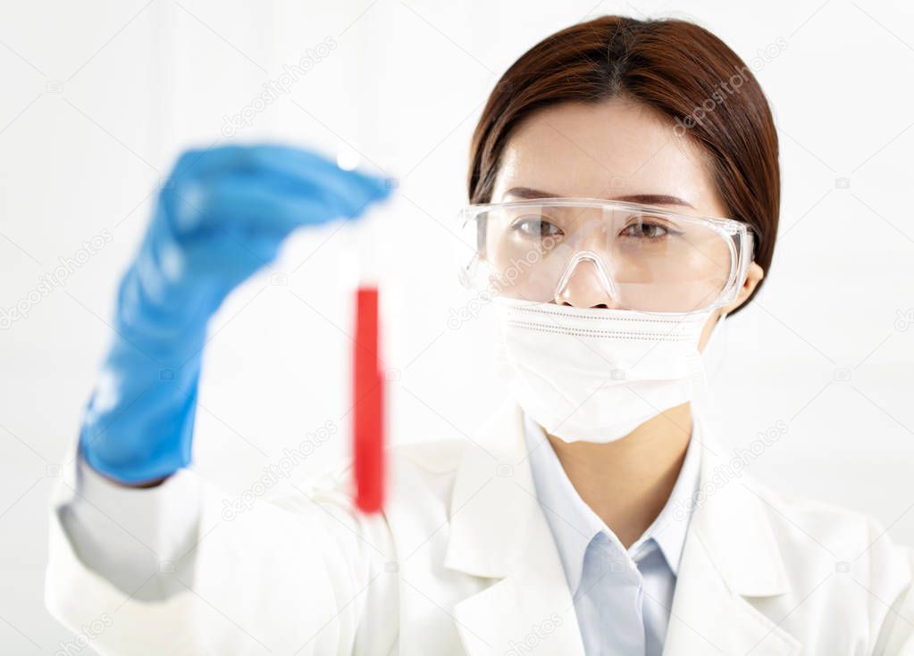  female scientist looking at test tube