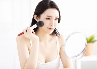 Aynaya bakıyorum ve kozmetik uygulama güzel kadın 