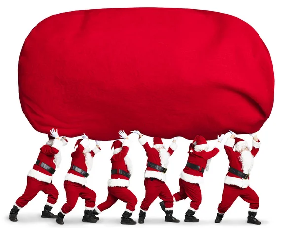 Beaucoup Père Noël Portant Grand Lourd Sac Cadeau Rouge — Photo