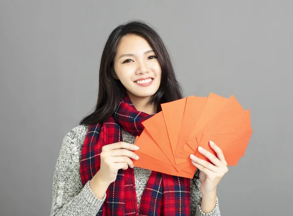 asian woman showing red envelopes for chinese new year