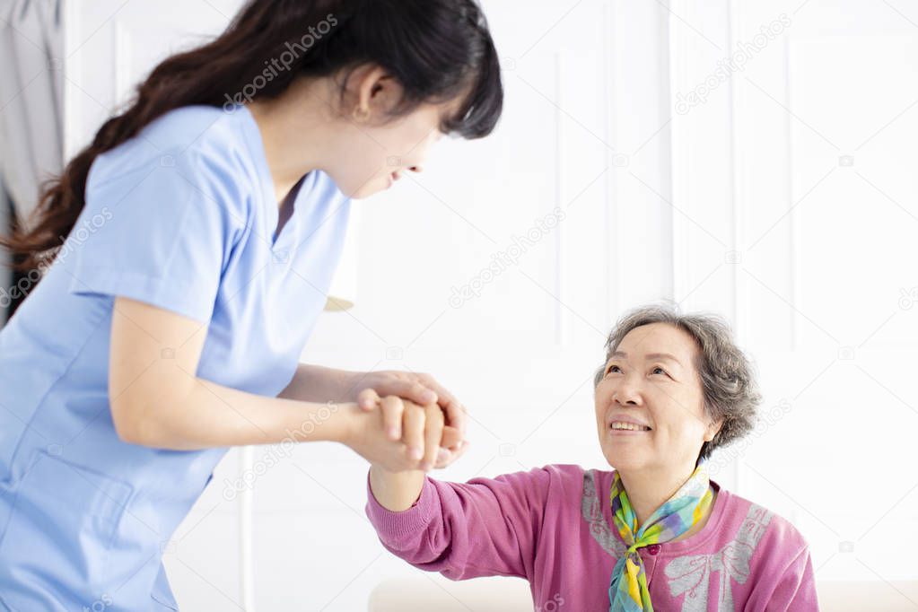 Health visitor and  senior woman during home visit