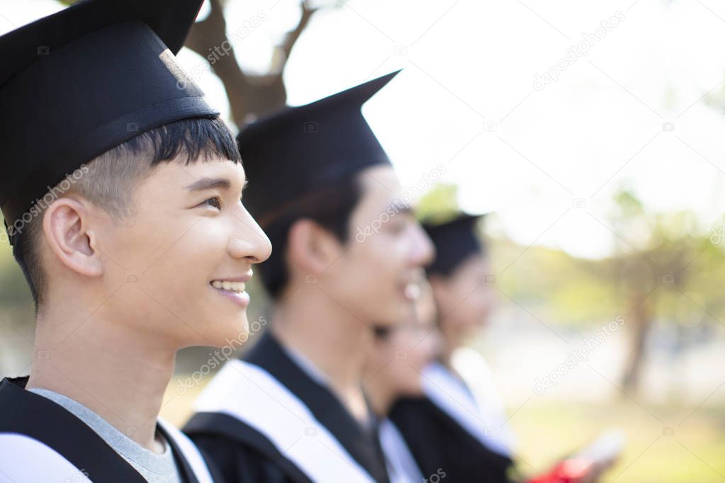 smiling asian young man at graduation 