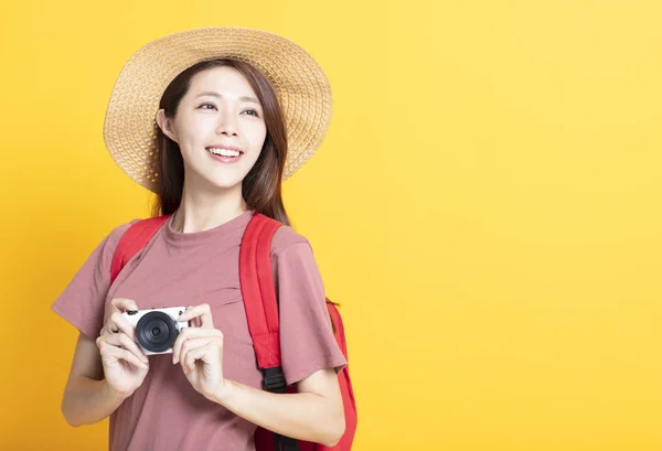 Felice giovane donna in cappello estivo e tenendo la macchina fotografica — Foto Stock
