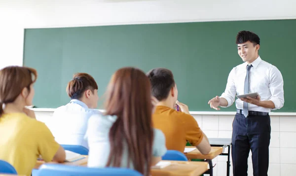 Učitel se skupinou vysokoškolských studentů ve třídě — Stock fotografie