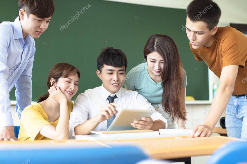 teacher with group of college students in classroom