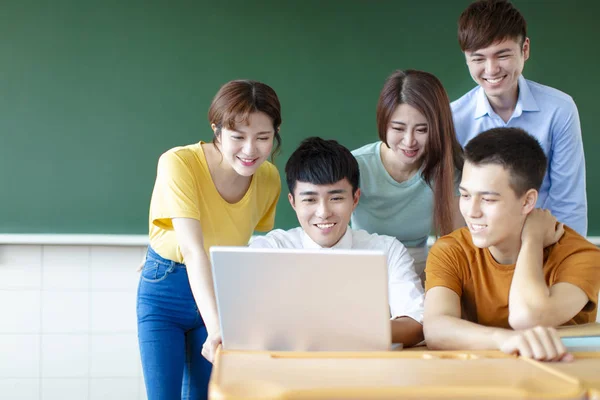 Class Of University Students Using Laptops In classroom