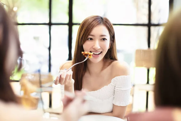 Young woman with friends having dinner in the restaurant — 스톡 사진