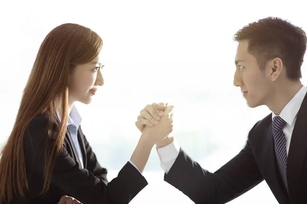 business woman VS business man arm wrestling