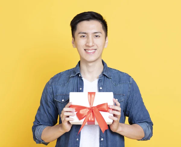 Glimlachend knappe man Holding Gift Box — Stockfoto