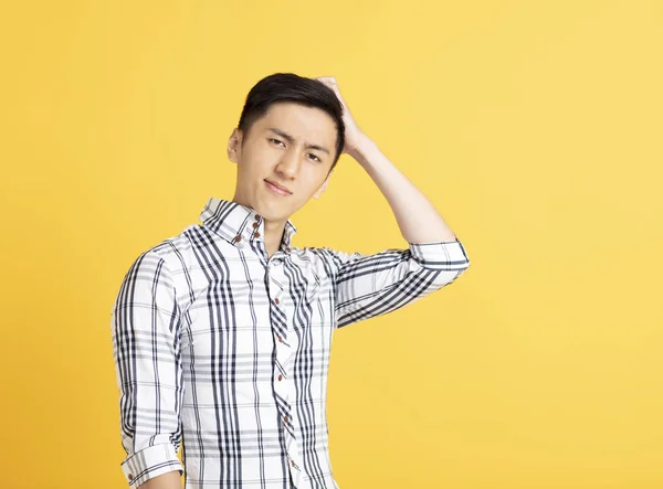 Confused asian young man thinking — Stock Photo, Image