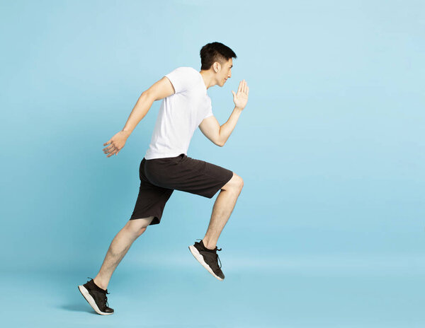 Full length portrait of young fitness man running