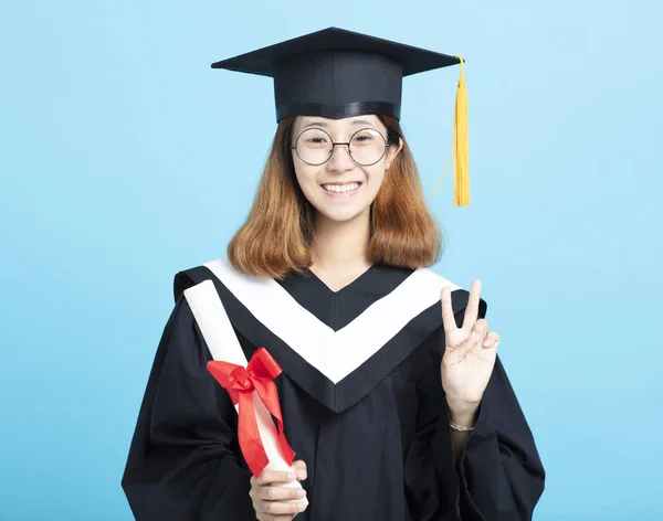 Happy success graduation girl with victory gesture — Stock Photo, Image