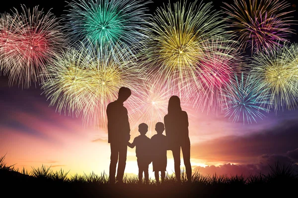 Happy family standing and watching the fireworks — Stock Photo, Image