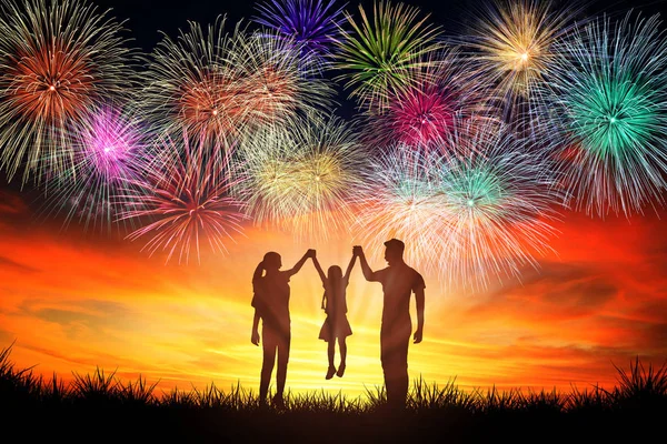 Happy family standing and watching the fireworks — Stock Photo, Image