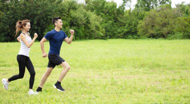 çim üzerinde çalışan genç çift yan görünümü