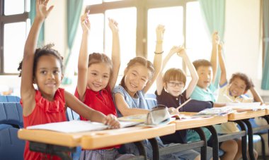 Smiling elementary school kids  in classroom clipart