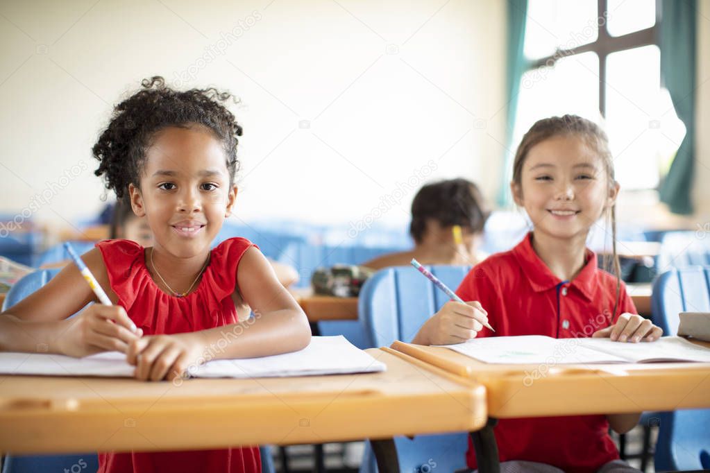Smiling elementary school kids  in classroom