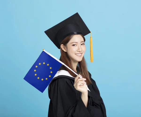 happy Young female graduation student showing the European Union