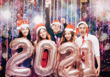 young group celebrating new yew 2021 in christmas party clipart