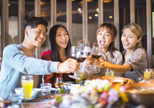 Happy friends having fun in hot pot restaurant — Stock Photo, Image