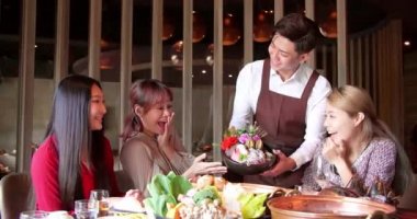 Mutlu garson restoranda servis yapan arkadaş grubuyla birlikte güveç getir..