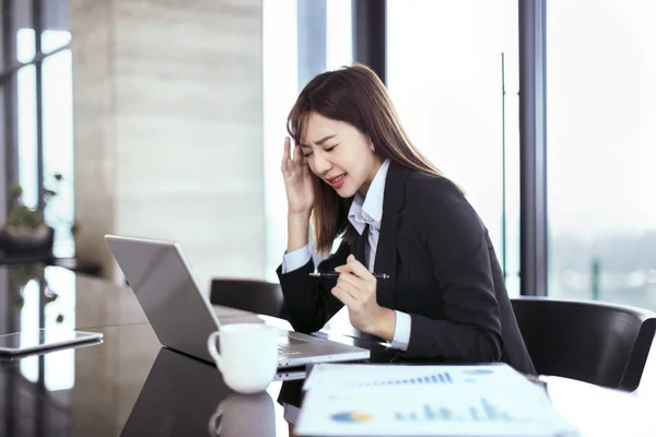 tired and stressed business woman working in office