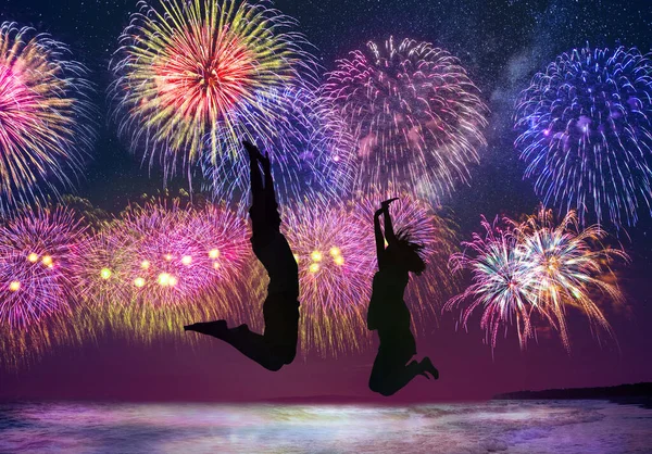 Young Happy Couple Jumping Beach Watching Fireworks — Stock Photo, Image