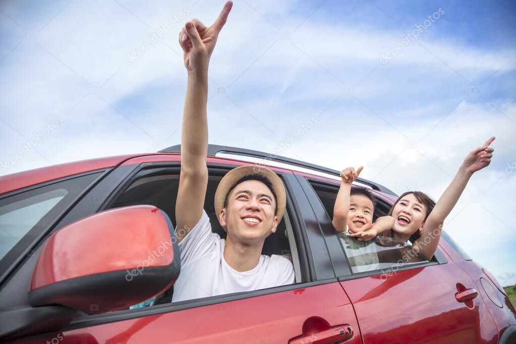 Happy asian family on  road trip in the car