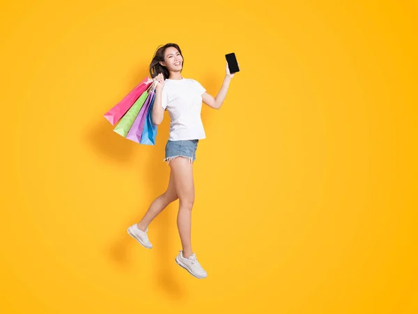 Happy Young Woman Holding Shopping Bags Showing Phone — Stock Photo, Image