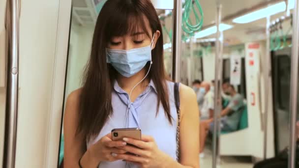 Young Asian Woman Passenger Wearing Surgical Mask Listening Music Mobile — Stock Video