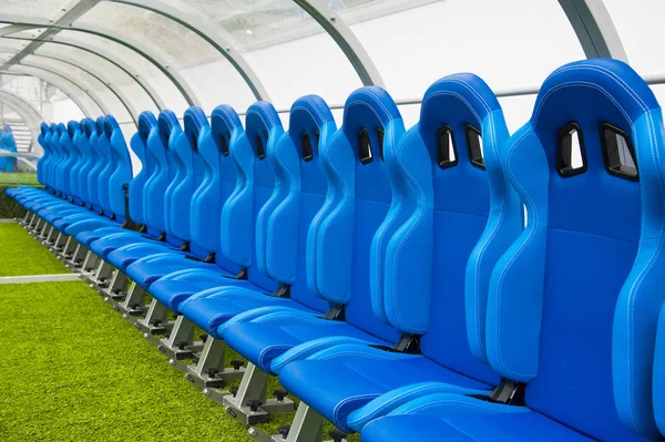 View of blue bench or seat or chair of staff coach in the stadium of football