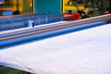 Endüstriyel kumaş üretim hattı. Bir tekstil fabrikasında dokuma tezgahı
