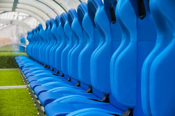 View of blue bench or seat or chair of staff coach in the stadium of football