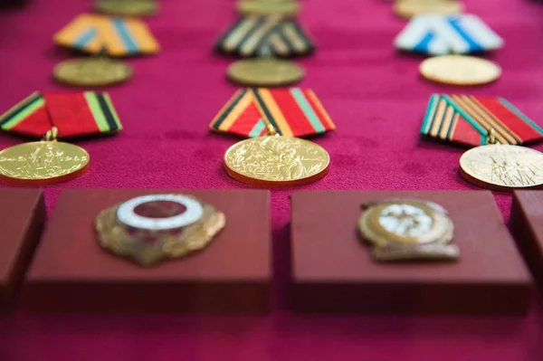 Old retro and modern military orders and military medals on red background